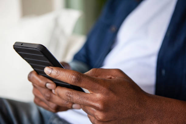 istock Medium shot view of unidentified person's hands typing on smartphone screen 2157154302