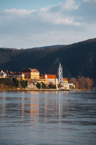 istock A European town on the riverside, surrounded by mountains, basks under the sunlight 2157154742
