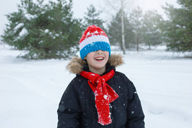 istock Happy boy in bright winter clothes and a red scarf 2157157121
