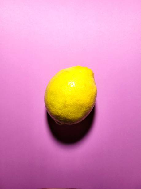 istock Yellow lemon on a purple background. 2157162449