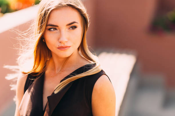 A girl with a beautiful makeup looks into the camera. close-up