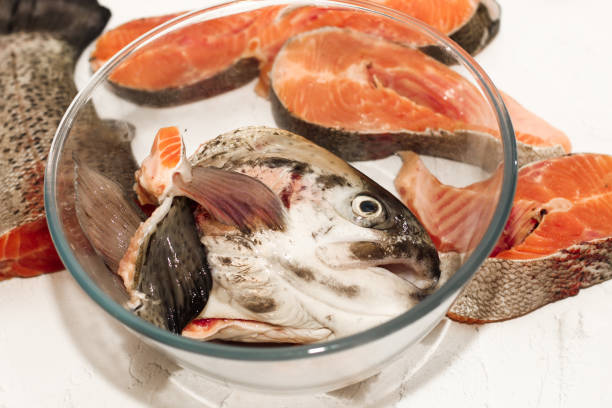 Woman preparing sea bass fish