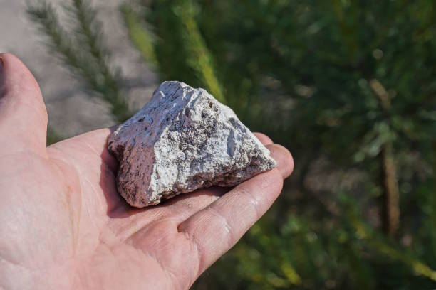 istock a man hand holds a one white piece of stone 2157165468