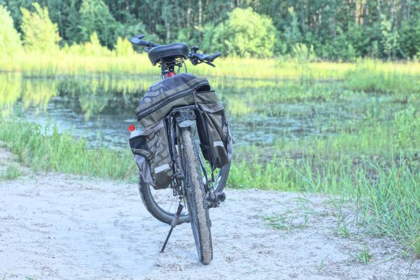 istock one black bicycle stands on the white sand 2157165555