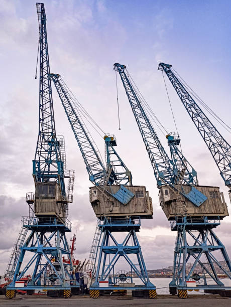 istock Large cranes at a port, with a clear sky 2157165644