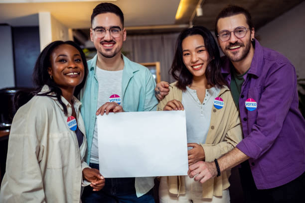 istock Diverse group of people stands proudly together, after voting 2157165666