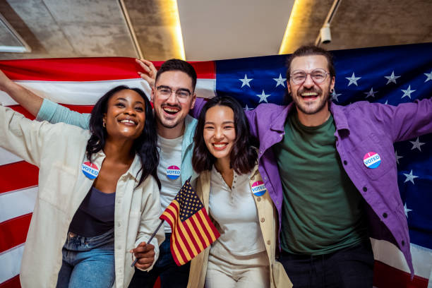 istock Diverse group of people stands proudly together, after voting 2157165670
