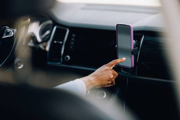 Person Using Smartphone Mounted in Car During Drive