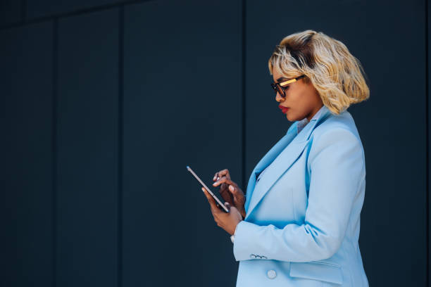 istock Confident Businesswoman Using Tablet for Work Outdoors 2157165952