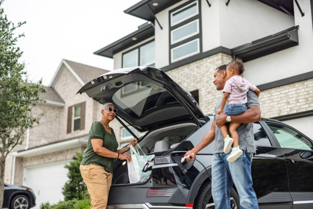 istock Grandmother and Grandfather Unloading Electric Vehicle 2157166024