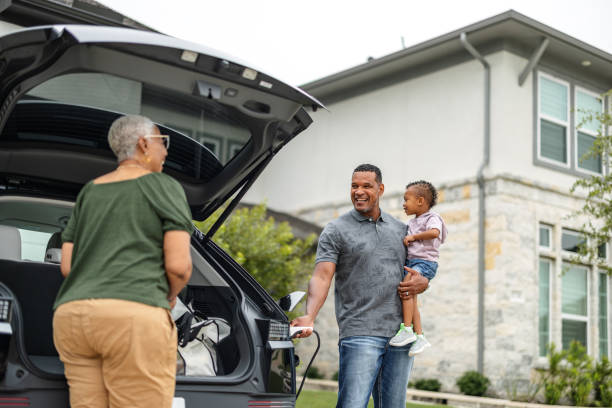 istock Multiethnic Family Charging Their EV and Unloading Car 2157166084