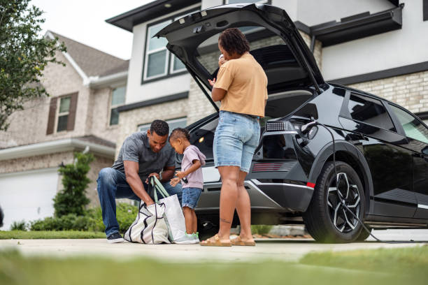 istock Multiethnic Family Unpacking EV with Solar-Powered Home 2157166096
