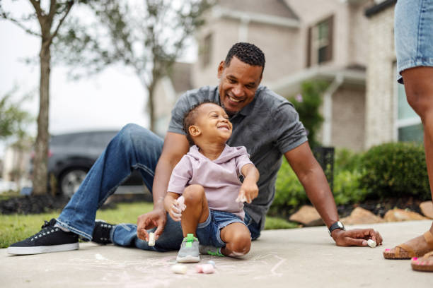 Father and Son Playing with Chalk Outdoors