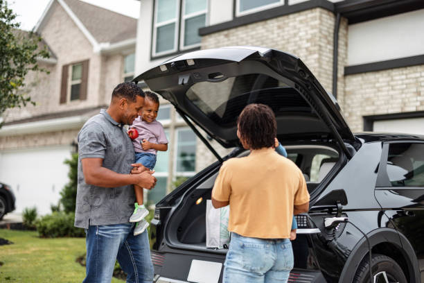 istock Happy Multiethnic Family Coming Home and Charging EV 2157166125