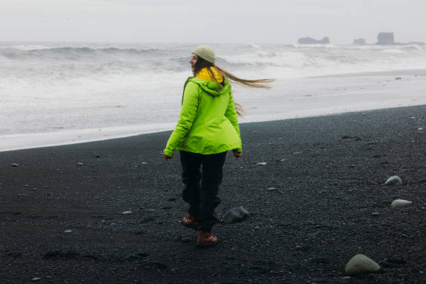 istock Happy Woman Admiring Dramatic Black Sand Beach Landscapes 2157166529