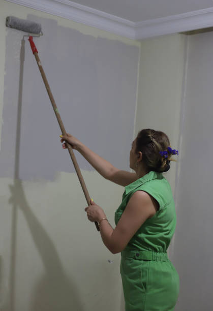 istock Woman painting with roller brush 2157169157