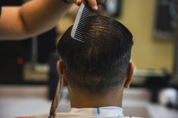 istock A man getting his hair cut at the barber 2157171275