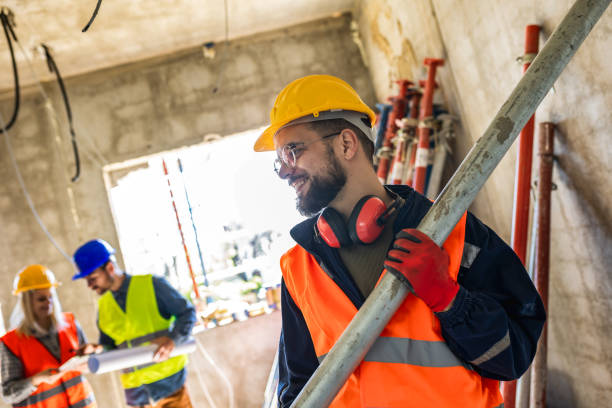 istock Two construction workers carrying a scaffolding at a building site - people at work concepts 2157171985