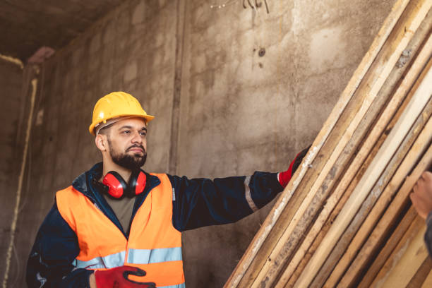 istock Two construction workers carrying a scaffolding at a building site - people at work concepts 2157172072