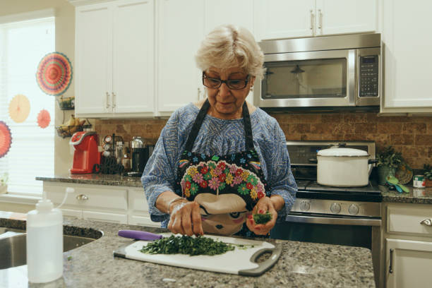 istock Senior Woman Cooking in a Home Kitchen 2157172077