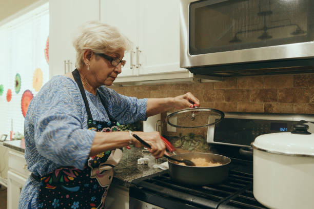 istock Senior Woman Cooking in a Home Kitchen 2157172091