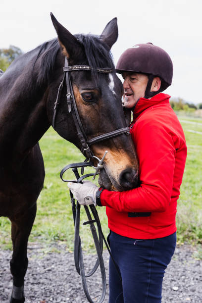 istock Retired Man Petting Horse's Head in Countryside 2157175588