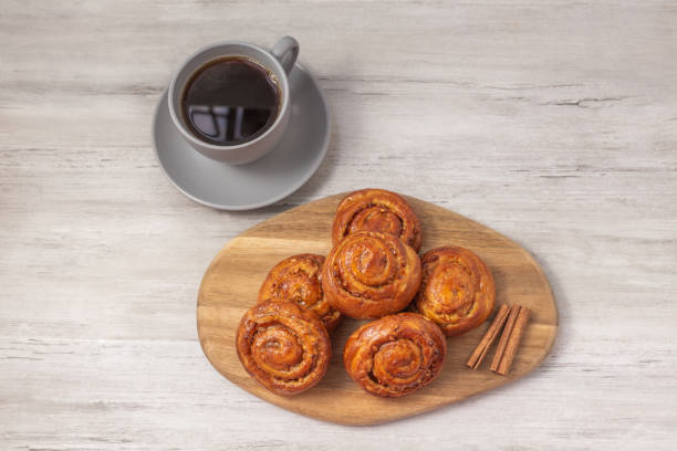 istock Sweet rolls with cinnamon on wooden board. Caramel buns with nuts. 2157178296