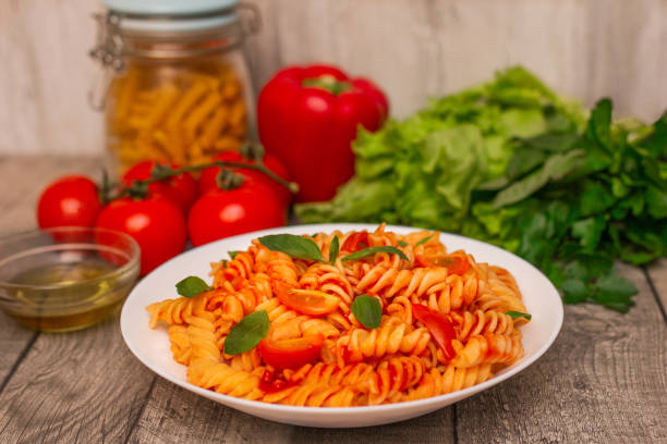 istock Italian pasta on plate on grey wooden background. 2157178526