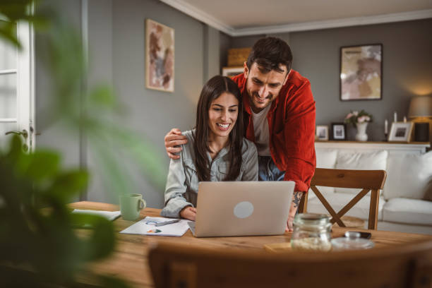 istock Woman work from home on laptop while boyfriend help and support her 2157179275