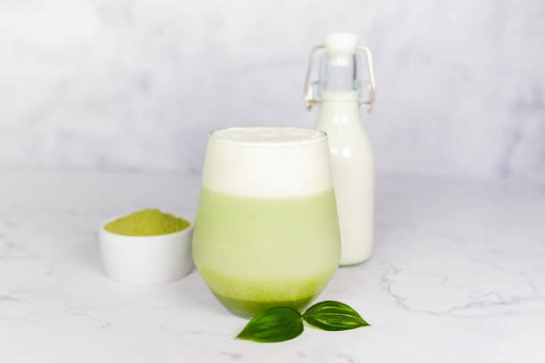 istock Refreshing matcha latte with powder or matcha with milk placed on white marble surface. 2157180499