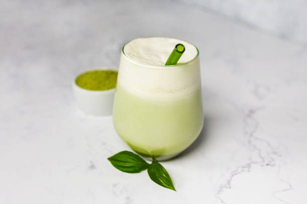 istock Refreshing matcha latte with powder or matcha with milk placed on white marble surface. 2157180513
