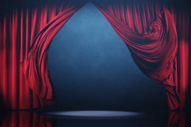 istock Red curtains in motion. Theater stage with smoke. 2157181128
