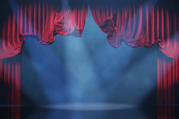 Theater stage with volume light and smoke. Red curtains in motion.