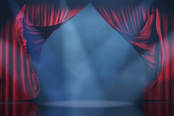 istock Theater stage with volume light and smoke. Red curtains in motion 2157181185