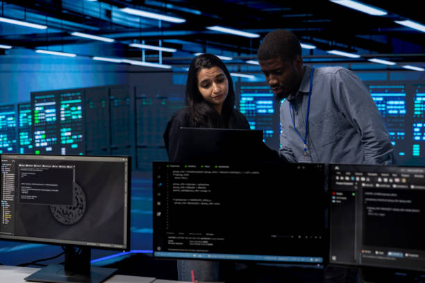 istock Coworkers in server room fixing equipment together 2157184680