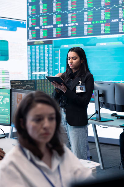 istock Team of forecast affiliates examining annual infographics on a big data screen 2157185469