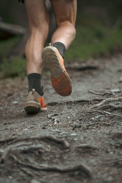 istock Man running down the mountain trail running race 2157186658