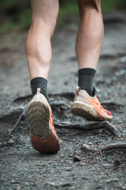 istock Man running down the mountain trail running race 2157186659