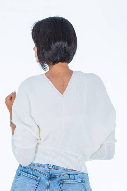 istock Latin woman dressed in a thread sweater which she models for the camera inside the photographic studio in which 2157191146