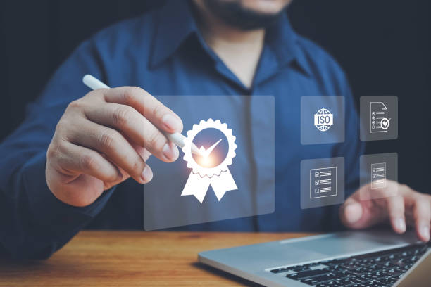 istock Quality ISO, ISO standards quality control, assurance and warranty business technology concept. Businessman using laptop computer with quality assurance and document icon for ISO, Standardization. 2157191387