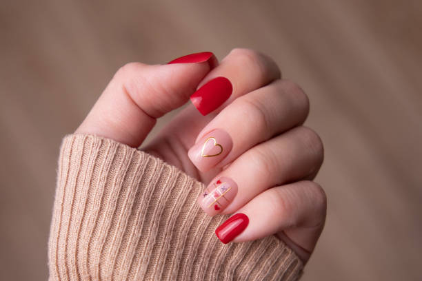 istock Female hand with red manicure nails, heart design 2157191774