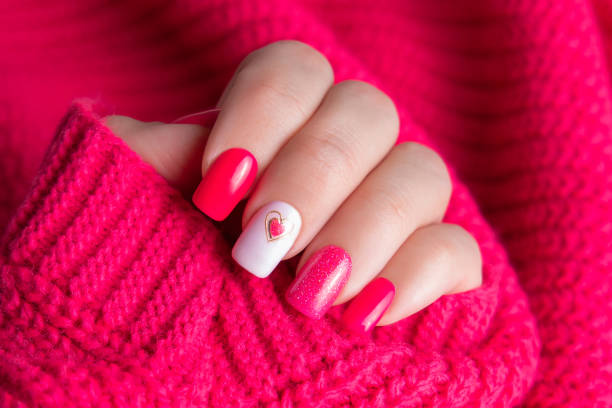 istock Female hand with pink manicure nails, heart design 2157191803