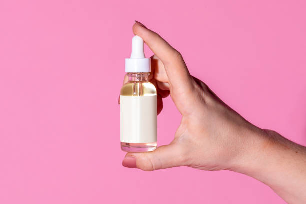 istock Woman holding a dropper bottle mockup 2157192285