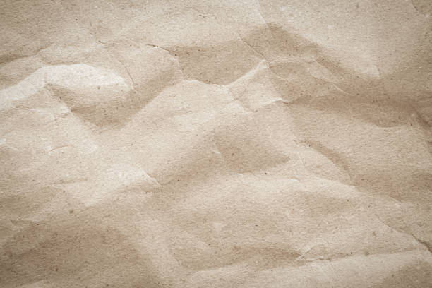 istock Old paper vintage texture surface for background. Recycle pale brown paper crumpled texture, Cream color recycled kraft paper texture blank with copy space for text. 2157195010