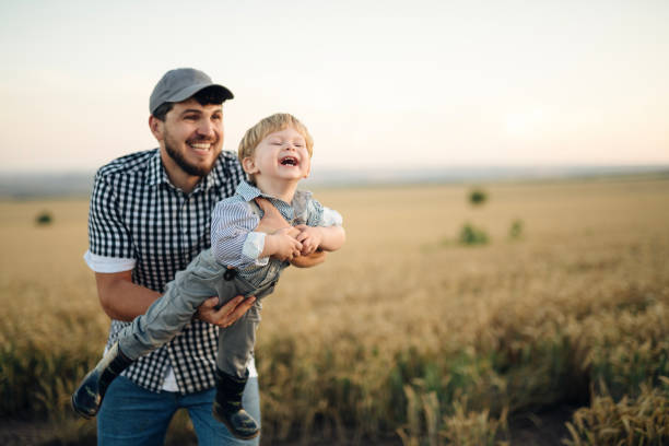 istock Father and son having fun on field at sunset. 2157195869