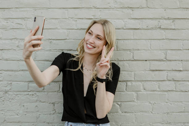 istock Cheerful blond woman taking a selfie 2157196323