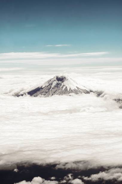 istock there is a tall mountain in the sky with clouds surrounding 2157197070