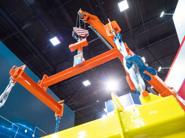 istock Crane boom. Equipment for lifting fragile goods. Crane inside hangar. Equipment for unloading goods. Production shop. Industrial equipment and technologies. Crane for industrial workshop 2157200217