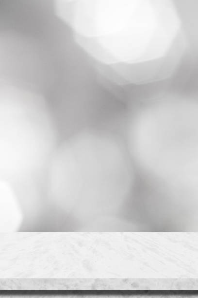 istock Empty white table top, counter, desk background over blur perspective bokeh light background, White marble stone table, shelf and blurred kitchen restaurant for food, product display mockup, template 2157200953
