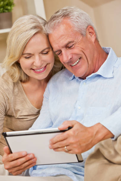 istock Happy Senior Man and Woman Couple Using Tablet Computer at Home 2157200970